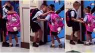 Sweet moment as boy hugs nervous little sister tightly at school