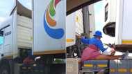 Woman seated outside moving vehicle to hitch ride on delivery truck, extreme video leaves Mzansi divided
