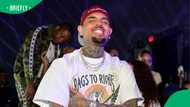 Chris Brown's steamy on-stage kiss with "married" fan sparks outrage as husband watches from crowd