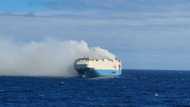 Burning cargo ship with Bentleys, Porsches and Volkswagens stranded in the Atlantic Ocean