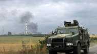 Road shelled as Russian forces battle for devastated Ukraine city
