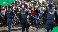 Protesters plead with SAPS members not to throw children in van in viral video