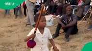 Zulu kid leads men in traditional chant and dance at gathering in video
