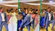 White groom sweeps the floor with traditional wedding step, outdances family members