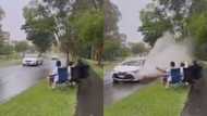 Splish splash: Hilarious video of men waiting for cars to drench them with water has peeps living