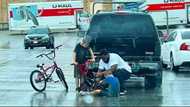 Kind man praised for braving the rain to fix young boy's broken bicycle