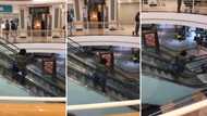 Woman walks down escalator going up in peculiar video, Peeps applaud the weird accomplishment: "She made it"