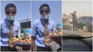 Young man in suit and tie sells goods in traffic, video goes viral