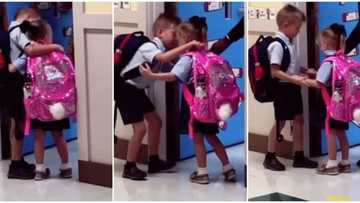 Sweet moment as boy hugs nervous little sister tightly at school