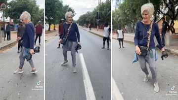 Music Legend PJ Powers plays soccer with township boys in Vilakazi Street in Soweto, SA amused