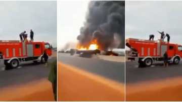 Reactions as video captures firemen using cans to refill truck during fire outbreak