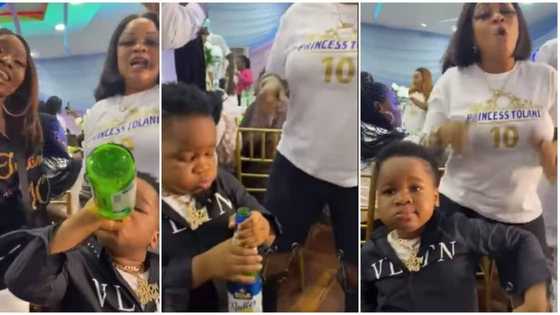 Little boy with '30 BG' chain on his neck drinks Star Radler at event, dances with ladies, video stuns many