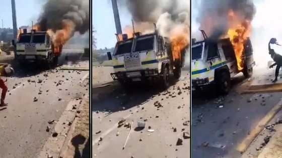 Mzansi reacts to video of police vehicle petrol bombed by rioters