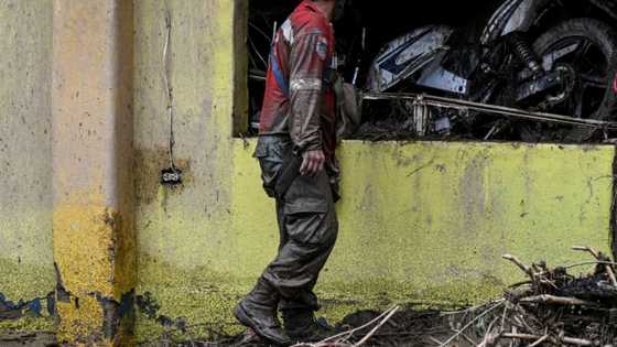 Neighbors, rescuers search for 52 missing after Venezuela landslide