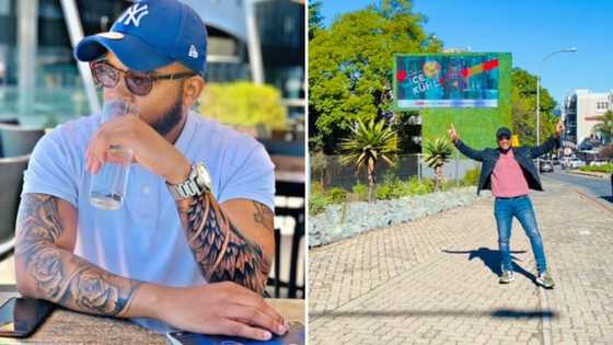 Proud man shows off a giant billboard with his face on it and the people of South Africa help hype him up