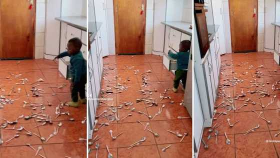 Toddler keeps busy by taking out countless spoons from kitchen cabinets