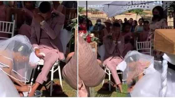 He go still cheat; Reactions as groom burst into tears as bride in her gown washes his feet at their wedding