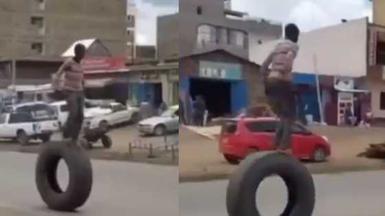 Daring man braves dangerous balancing act on truck tyre in busy road