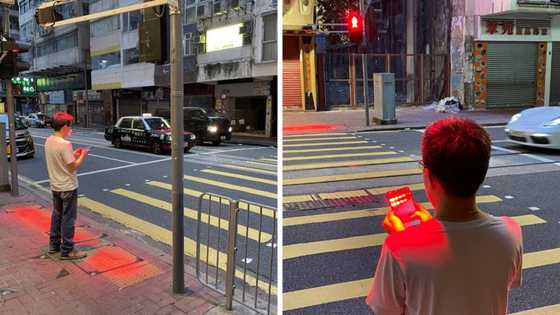 Pedestrians distracted by their smartphones are being targeted in Hong Kong's new traffic light tech