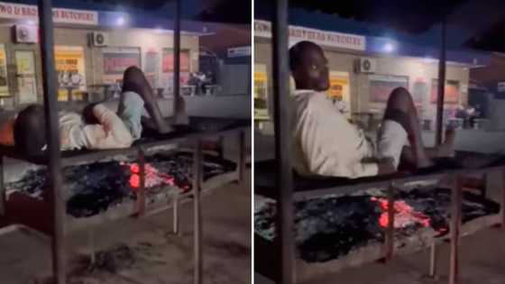 Video of man lying on braai with burning coals to keep warm in winter leaves Mzansi with mixed feels