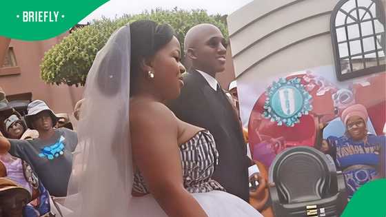 Groom cartwheels next to bride at wedding in a TikTok video