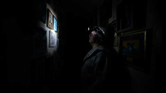 Defiance by candlelight as Kyiv adapts to blackouts