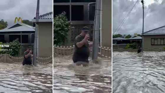 Man anchored to street pole in Cape Town floods casually sips the water: Mzansi lol over his level of chill