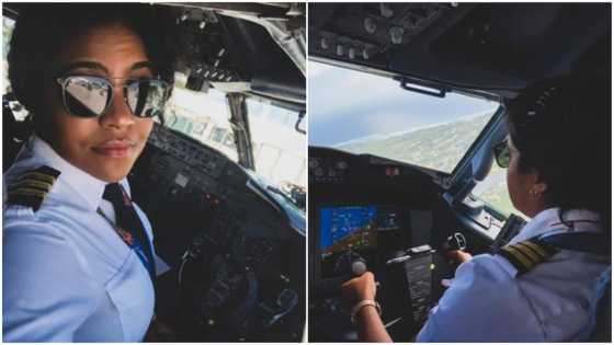 Beautiful female pilot poses in aeroplane, many people react