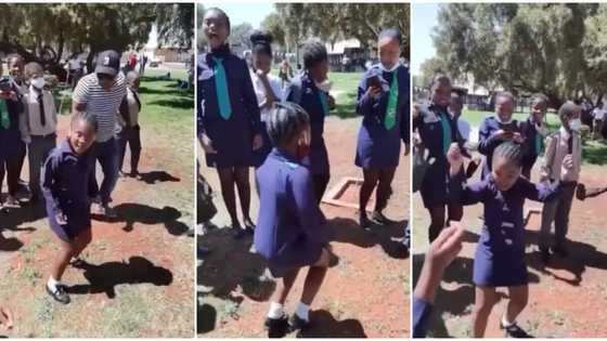 Little schoolgirl in long sleeves gives killer waist moves as she dances in front of students in cute video